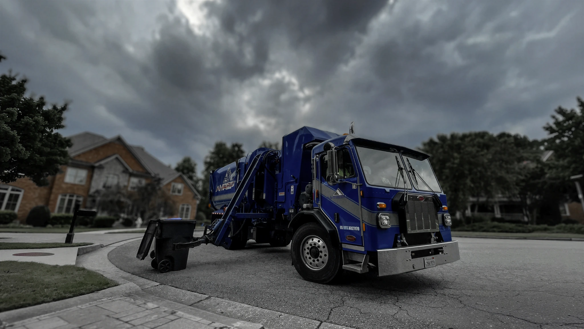 Amrep ASL picking up Toter trash can